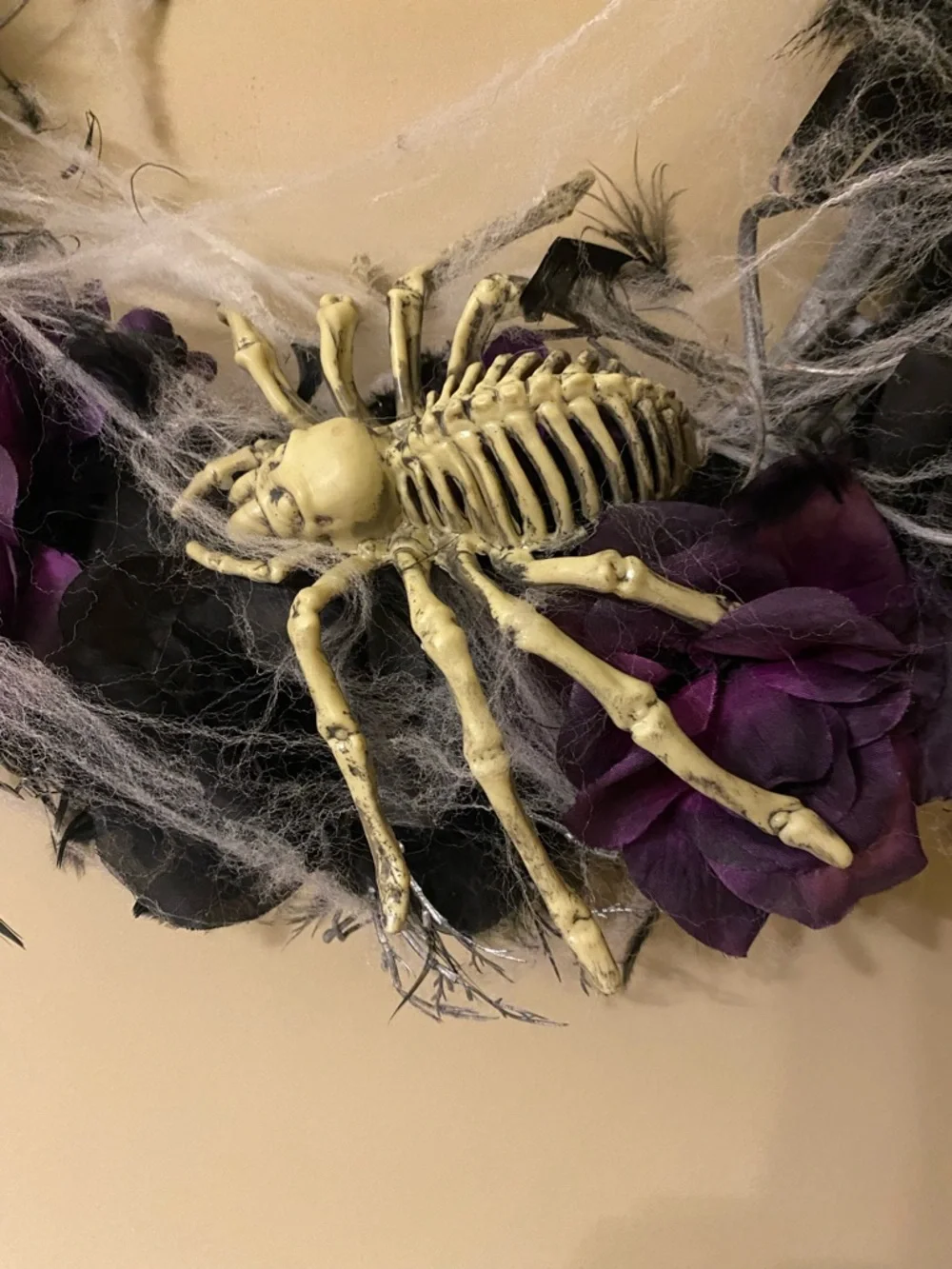 Halloween wreath with spider skeleton, flowers and cobwebs